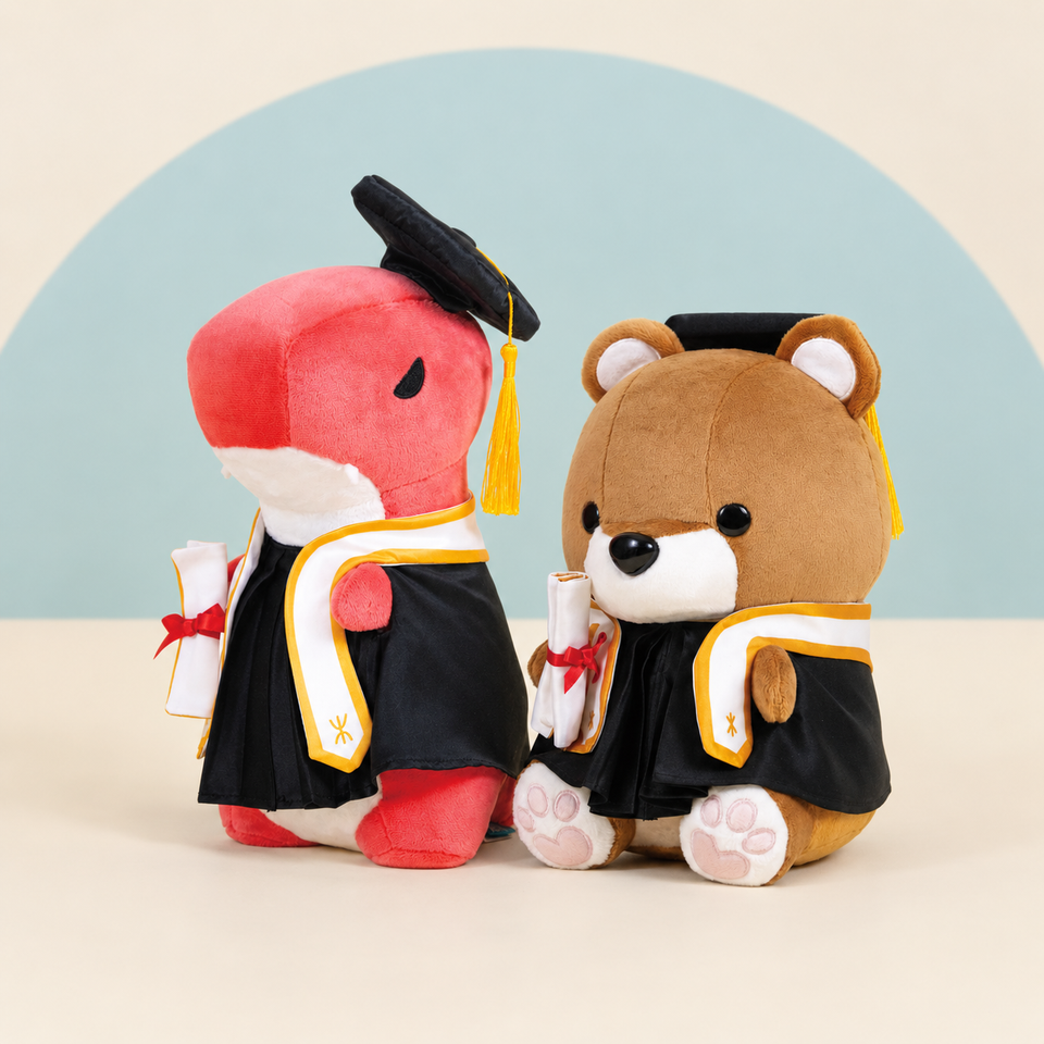 Graduation Rexxi and Graduation Teddi on a cream background with a soft blue curve