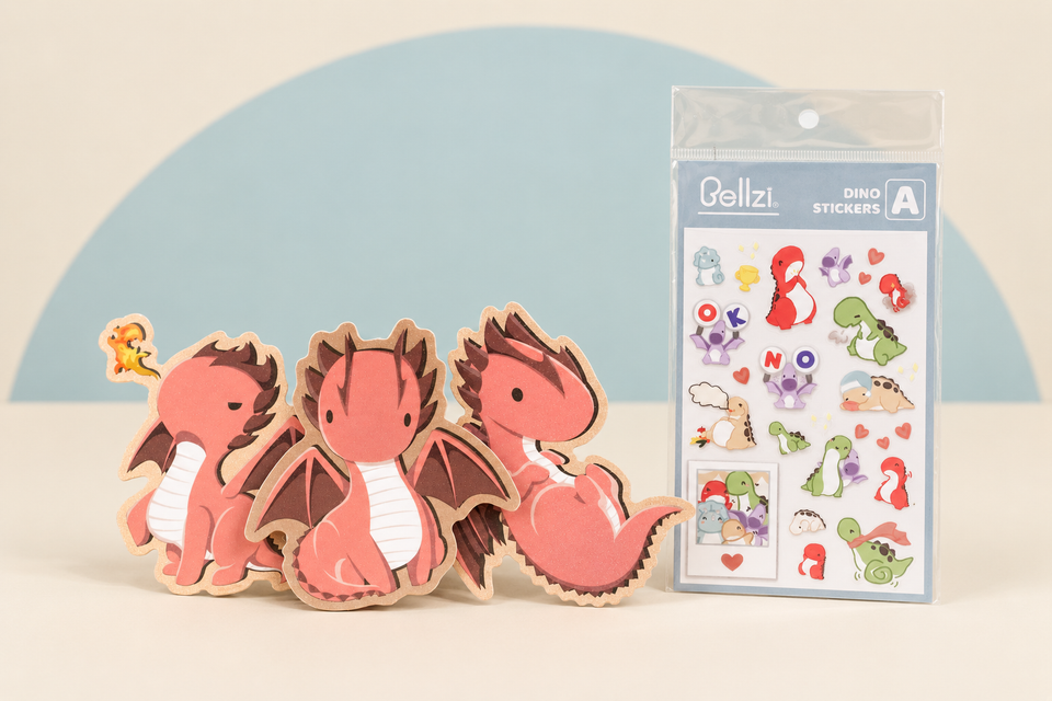 Draggi stickers and Dino Sticker Sheet A on a cream and soft blue studio background