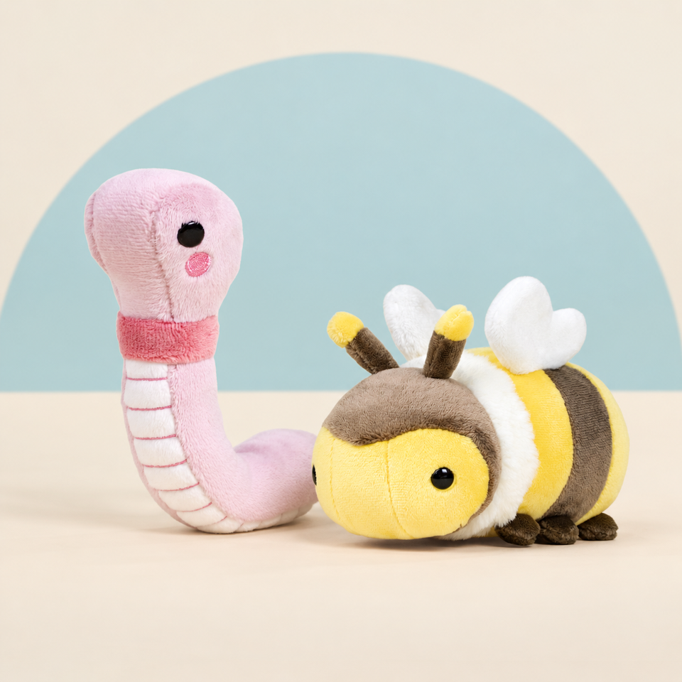 Mini Wormi the Worm and Mini Bii the Bee on a cream background with a soft blue curve