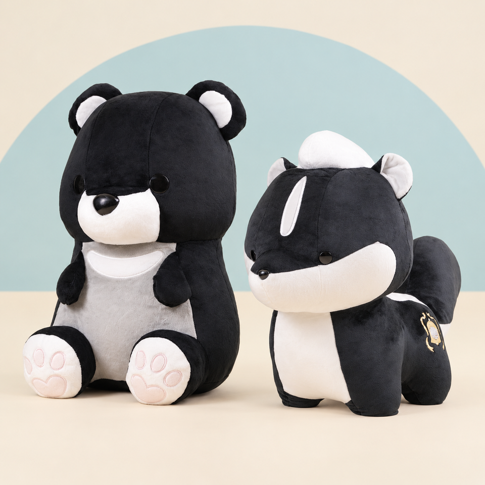 Giant Moonbi the Moon Bear and Giant Skunki the Skunk on a cream background with a soft blue curve