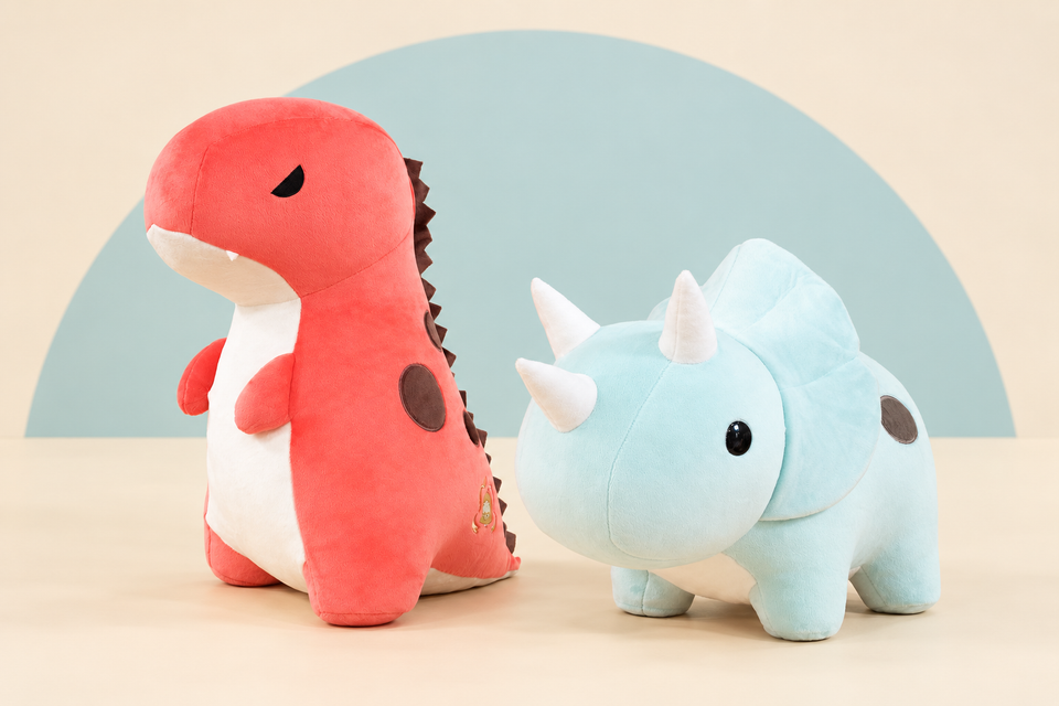 Giant Rexxi the T-Rex and Giant Seri the Triceratops on a cream background with a soft blue curve