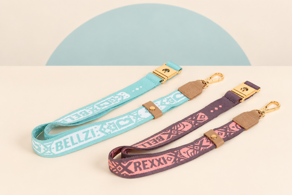 Bellzi Lanyard B and Rexxi Lanyard B on a cream background with a soft blue curve
