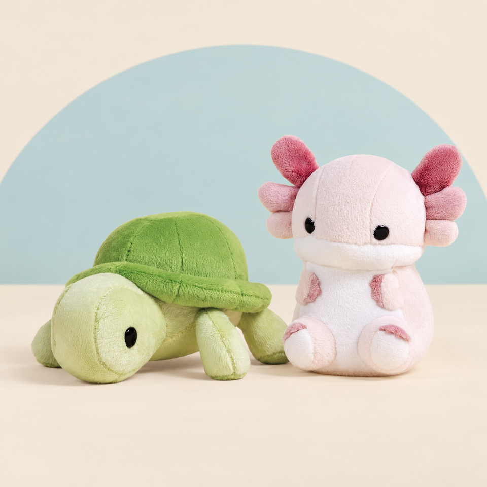 Mini Torti the Tortoise and Mini Lotti the Axolotl on a cream background with a soft blue curve