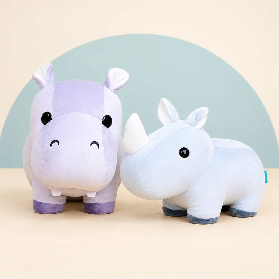 Giant Hippi the Hippo and Giant Rhini the Rhino on a cream background with a soft blue curve